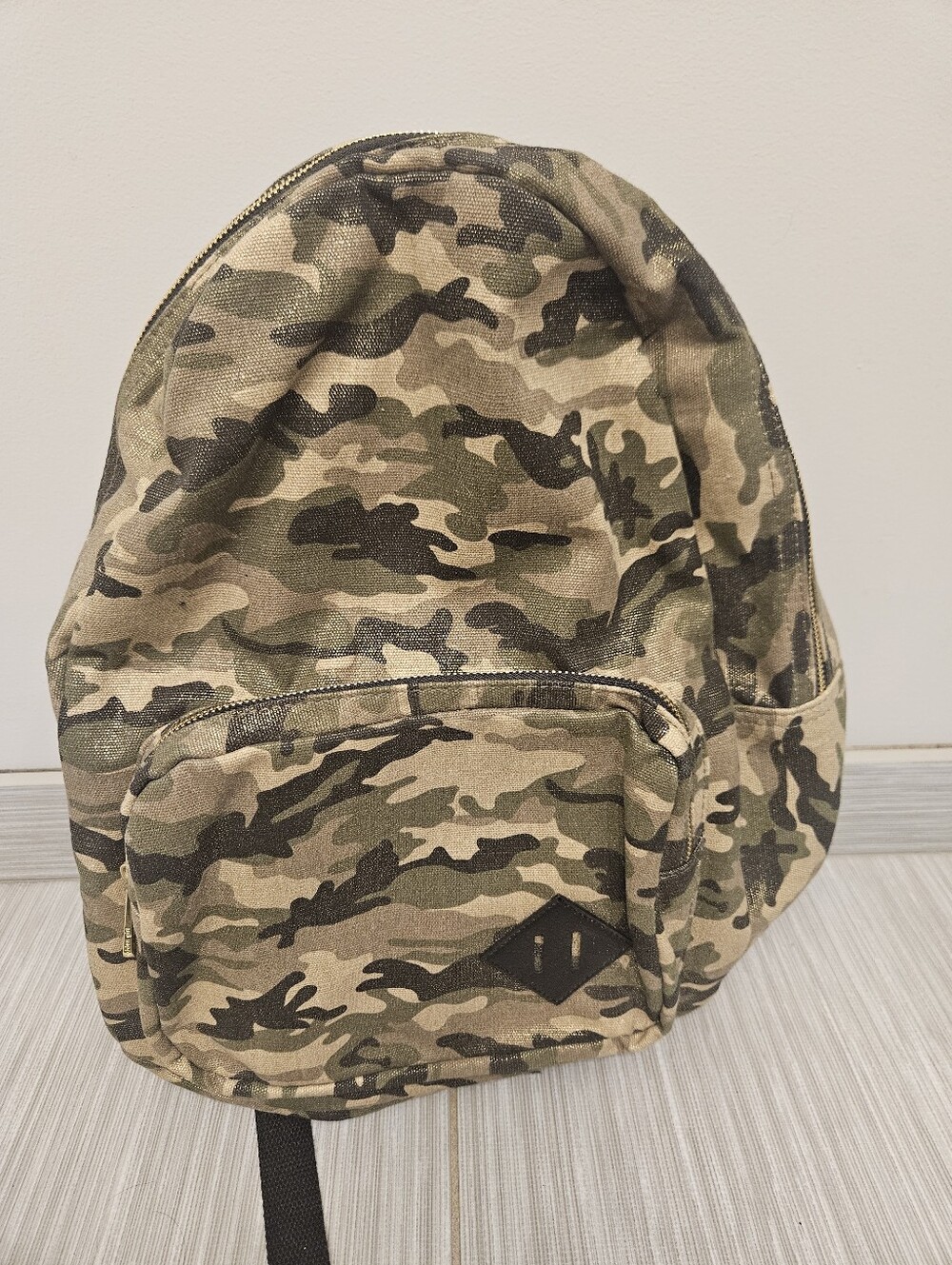 Madden Girl camouflage mini backpack featuring a metallic gold finish